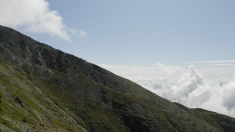 Aerial-View-of-Hiking-Trail-To-krivan-Mountain-Summit-Over-Clouds-On-a-Bright-Sunny-Day-in-Slovakia