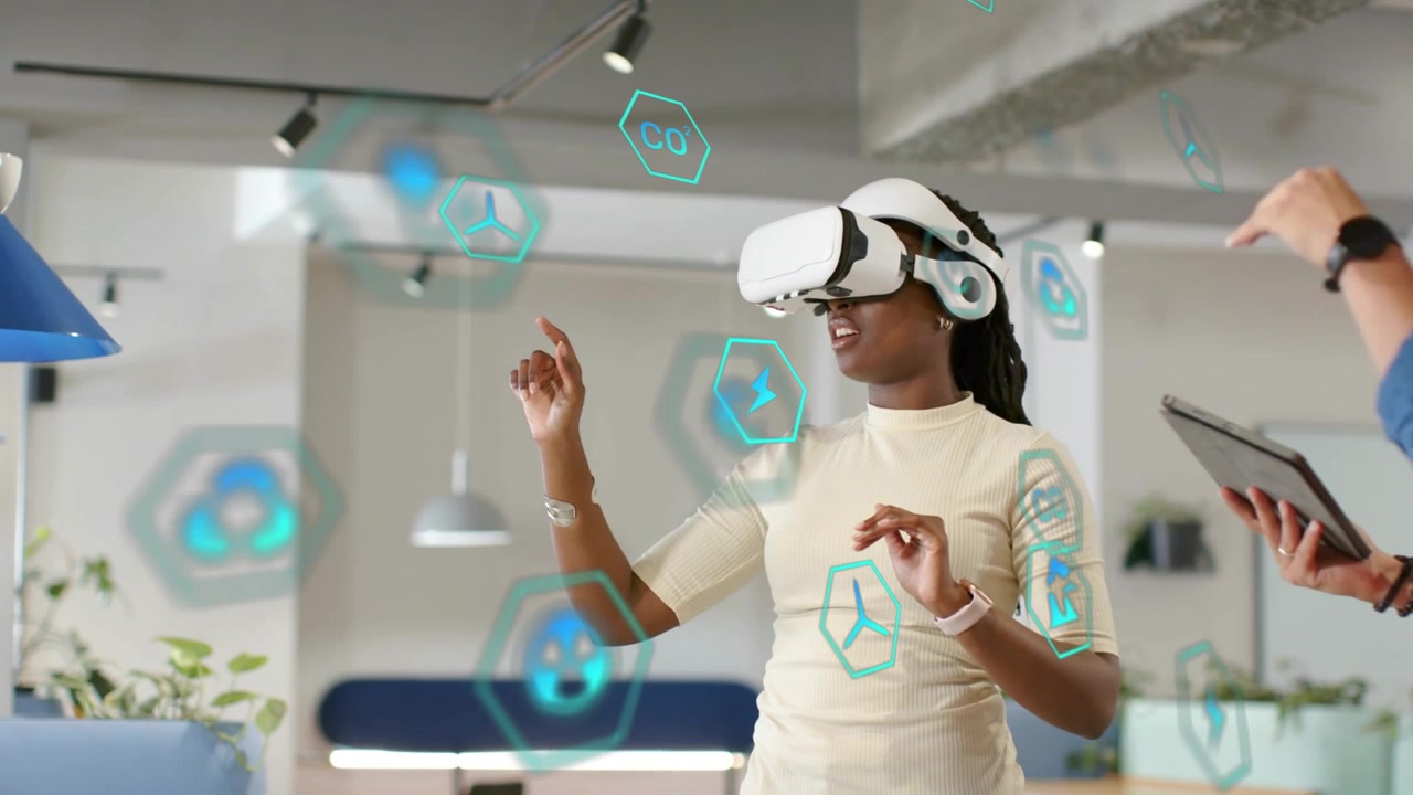 Woman in VR selecting hex icons after UI appearing, man guiding via tablet for tech demo