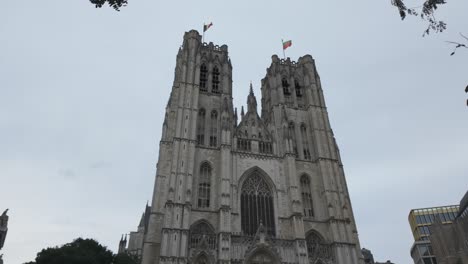 Gothic facade of St Michael Cathedral in Brussels with dramatic cloudy skyline.