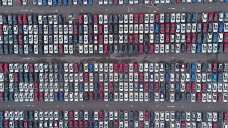 abstract aerial composition featuring systematic arrangement of vehicles creating visual data patterns, emphasizing geometric organization and scale of automotive logistics