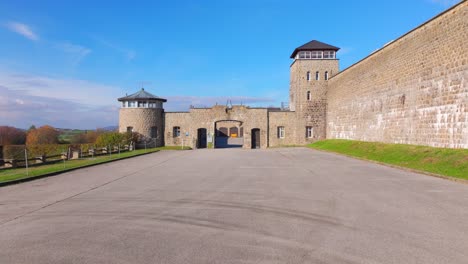 mauthausen, upper austria - exterior view of the main entrance of mauthausen concentration camp - drone flying forward