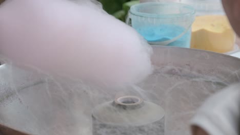 spinning pink cotton candy at a fair