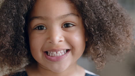 portrait beautiful little mixed race girl looking at camera happy child at home