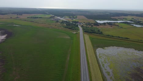 wide angle aerial drone shot grass fields and countryside in denmark