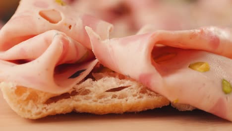 close-up of sliced salami on bread