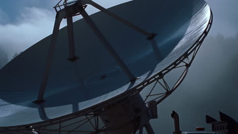 large satellite dish and vehicle at a scientific observatory
