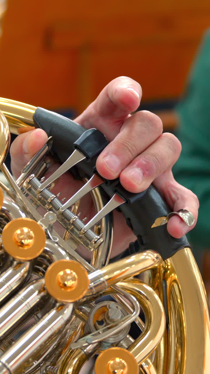 Close-up of Musician's Hand Playing French Horn Valves