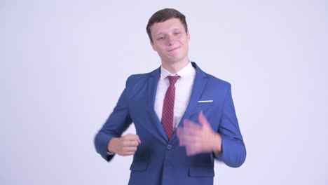 happy young handsome businessman in suit