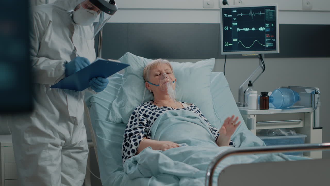 Doctor doing checkup visit for ill woman with oxygen tube