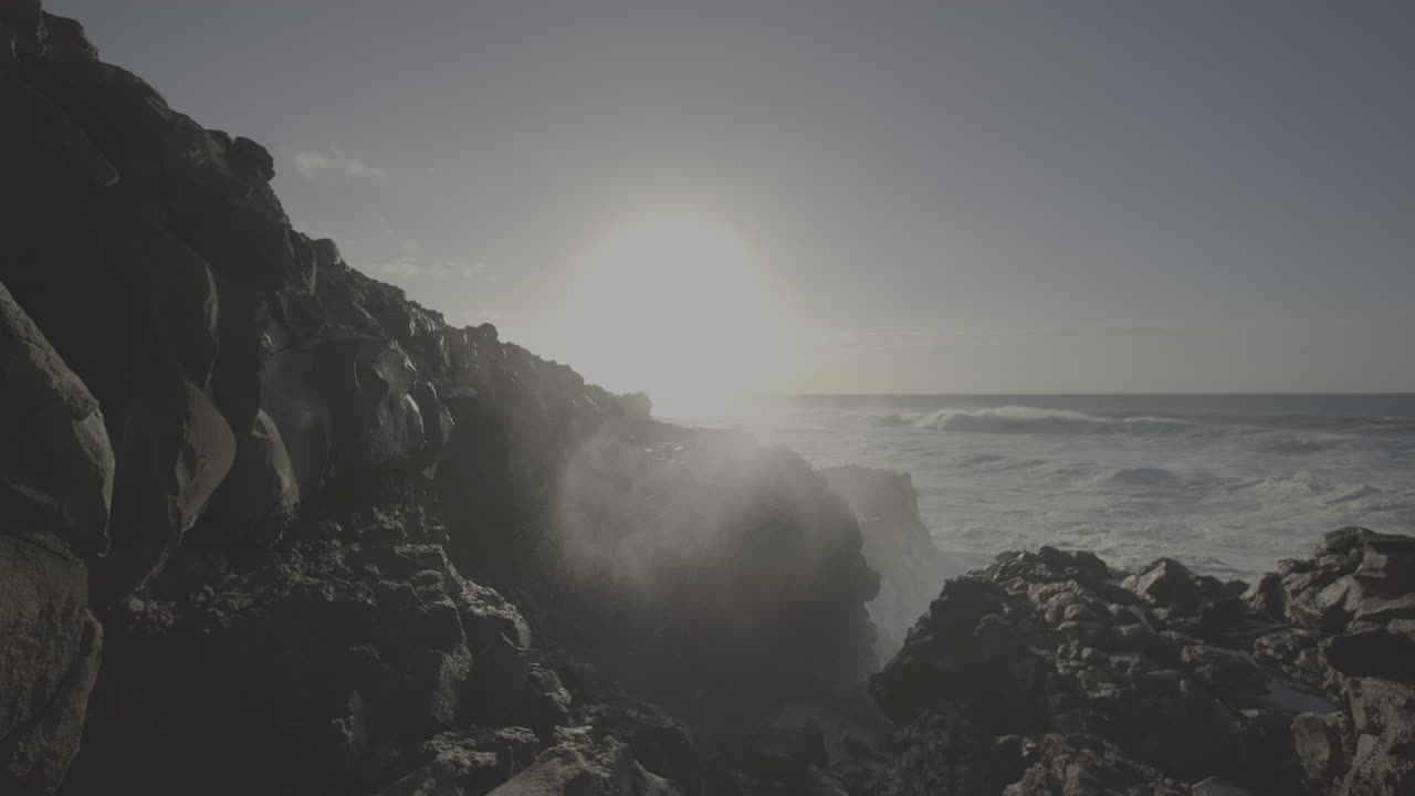 Powerful Waves Crashing on Volcanic Rocks at Sunset