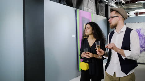 couple enjoying champagne at an art gallery