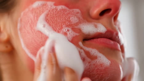 woman washing her face with foam