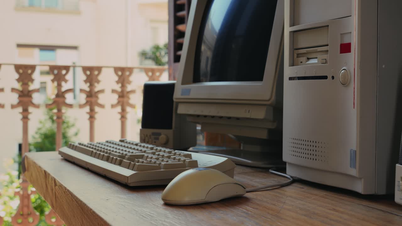 Man working and gaming on retro computer PC, IT engineer with vintage computer at home, using old fashion technology, close up of retro setup.