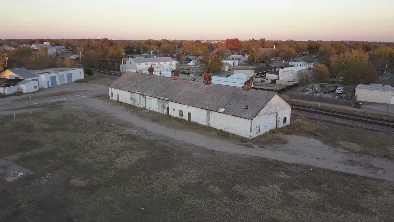 Abandoned rusty old white building with rusty air vents and metal roof