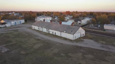 abandoned rusty old white building with rusty air vents and metal roof