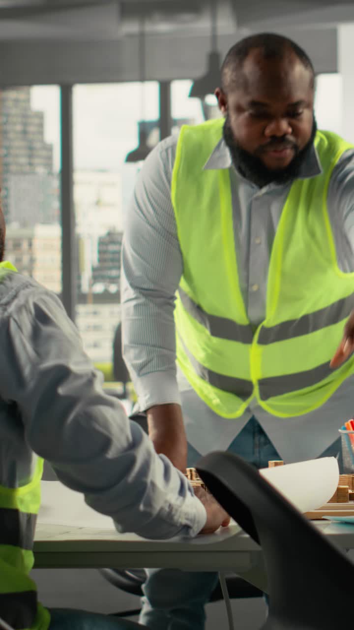 Vertical Video Multiethnic team of workers reviewing charts and diagrams in a briefing session