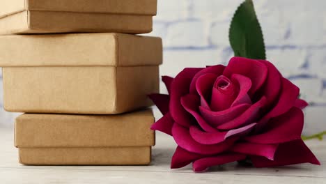 stack of gift box and rose flower on table