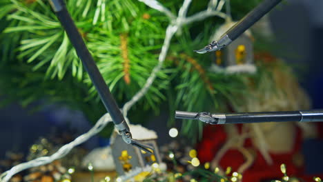 Gadget humanoid decorating Christmas tree while preparing to the holidays. Cropped view. Future technologies concept