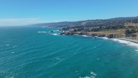 drone high above the ocean captures a vast seascape with the distant cliffs and shoreline of black point beach, california