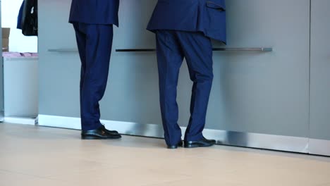 men in blue suits standing in line