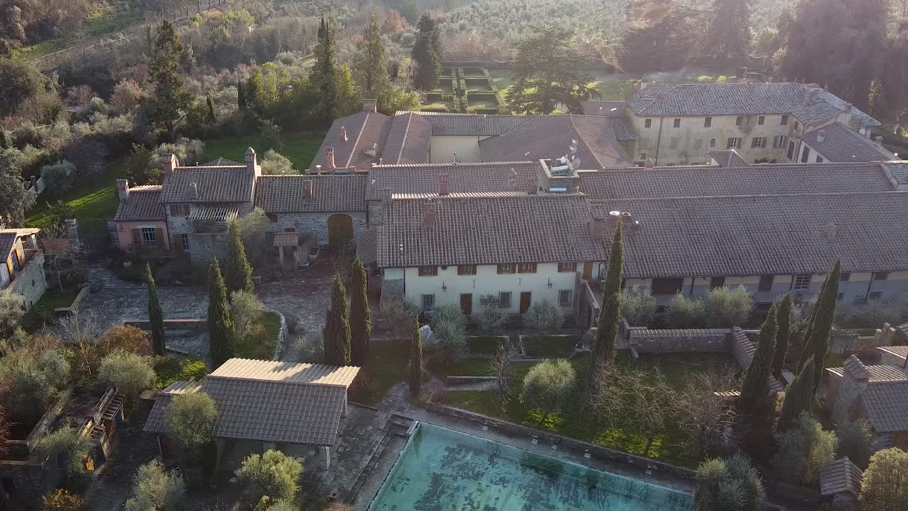 Focusing aerial of CasaMora 18th century agriturismo and homestead in the amazing Florence surrounding hills. Winter season at sunset, Piandisco Arezzo , Tuscany Italy
