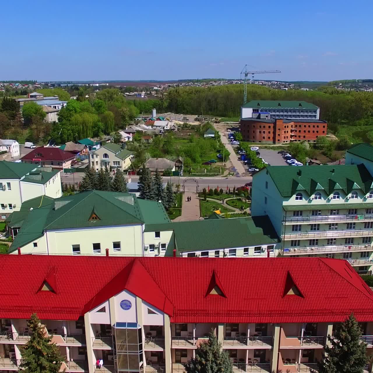 Newly built modern urban area with bright architecture. Sunny view of the provincial city on lovely summer day. Top view
