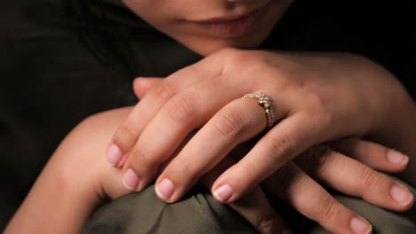 woman's hand with diamond ring