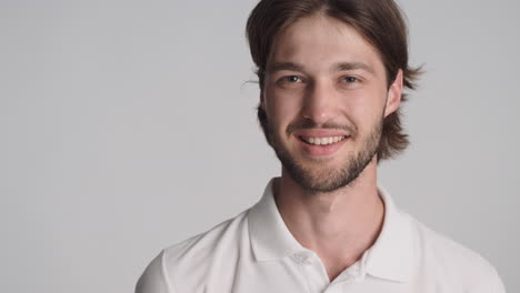 caucasian man in front of camera on gray background.