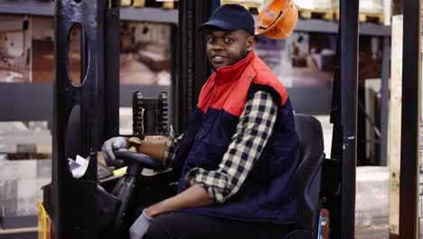 Forklift-operator-in-the-warehouse,-wearing-uniform-and-cap