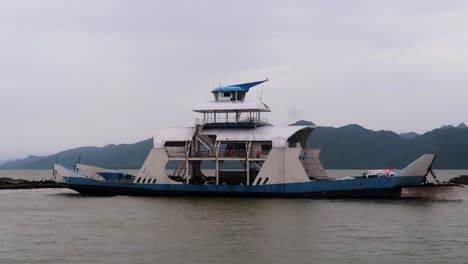 A-passenger-ferryboat-maneuvering-out-of-port-of-Koh-Chang-Island,-Thailand