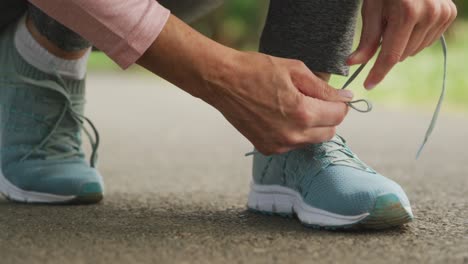 close up of woman tying shoe laces