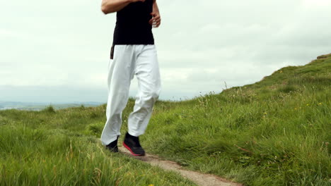 Fit-man-jogging-through-sand-dunes