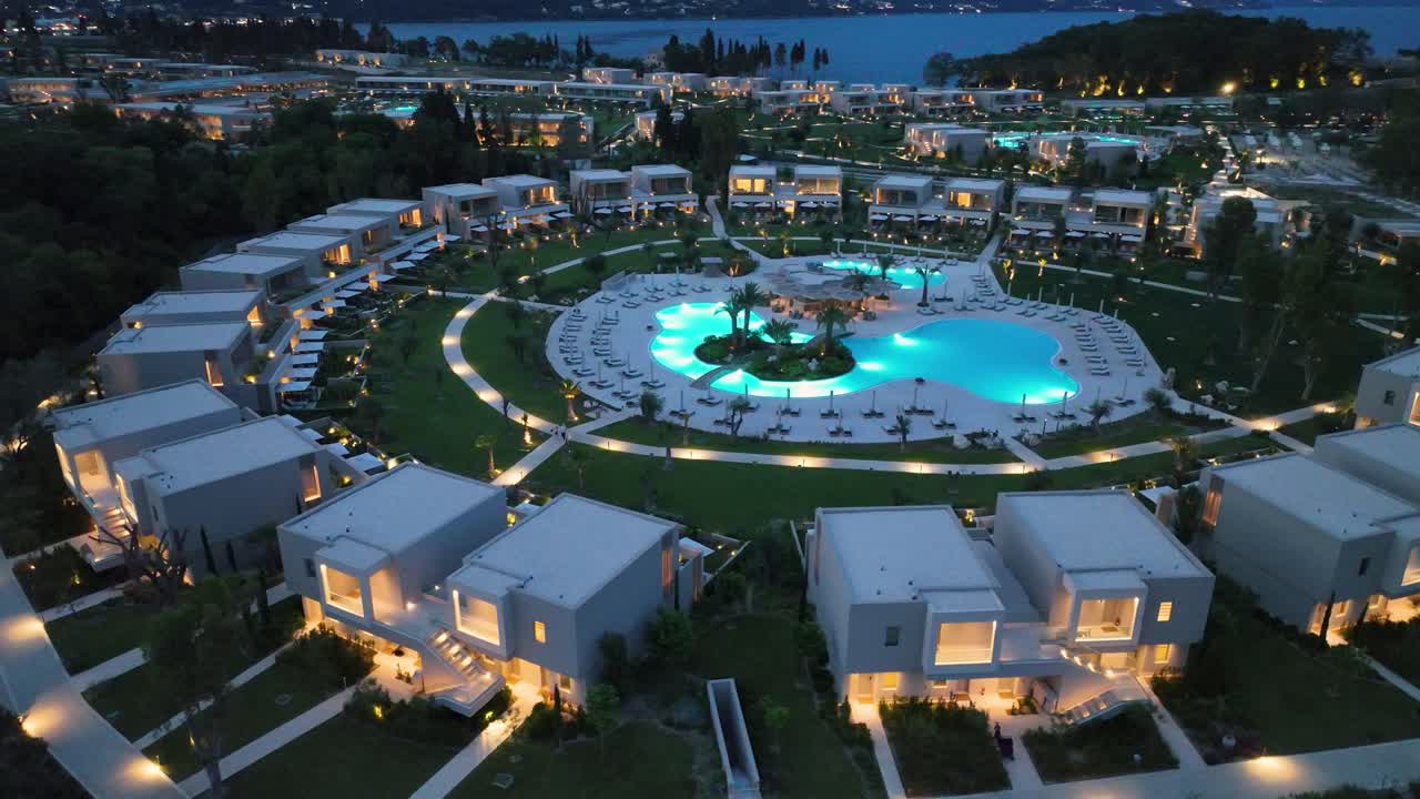 Aerial view of Illuminated Ikos Odisia, a Luxurious Seaside Escape in Corfu, Greece
