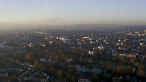 drone shot of the cityscape landscape of kassel in beautiuful soft sunlight and covered in fog