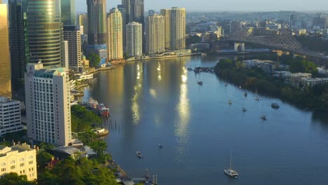 Yachts-And-Boats-Sailing-At-Brisbane-River-With-Story-Bridge-And-Brisbane-CBD-At-Daytime-In-Australia