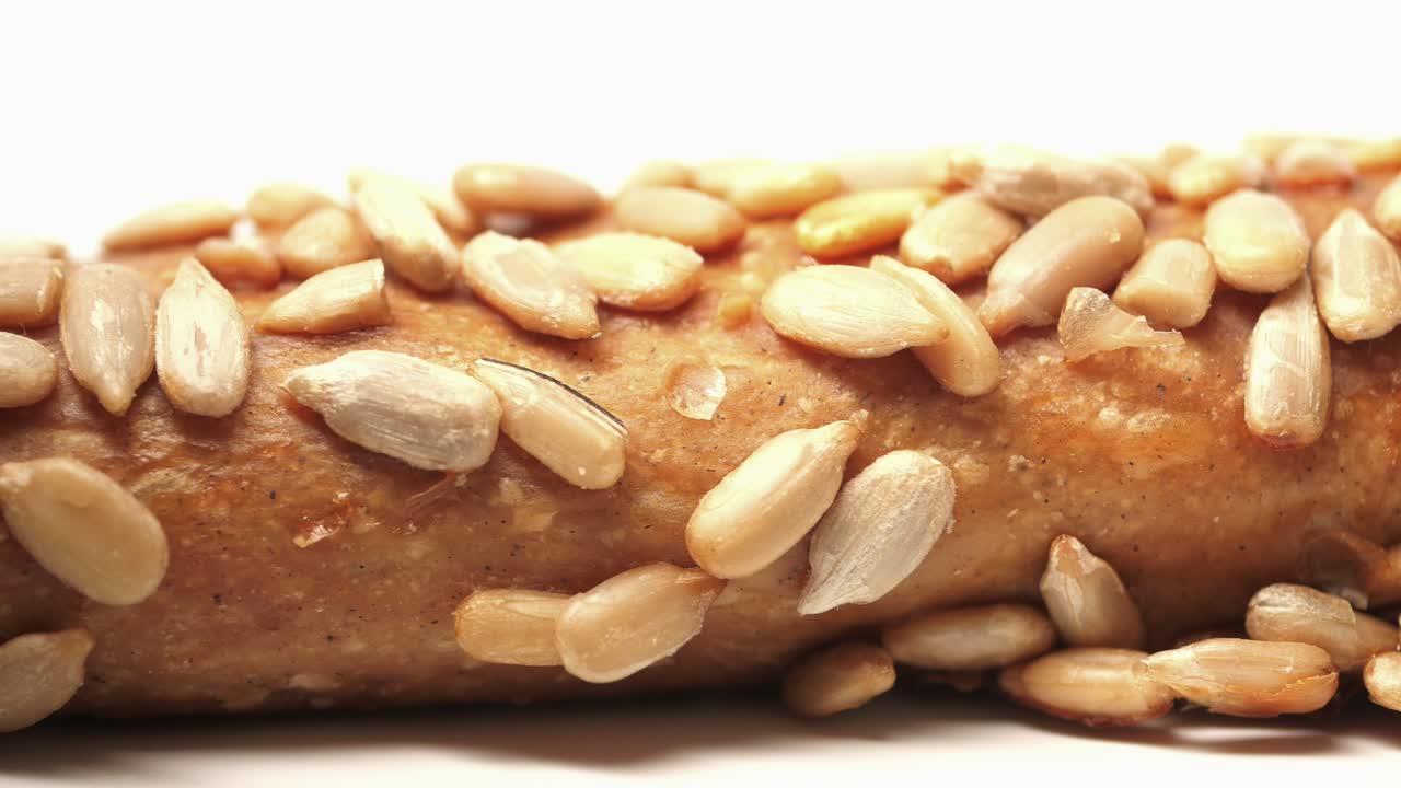 Close-up of a pretzel covered in sunflower seeds