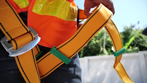 asian men worker wearing high safety, fall protection belt, close up