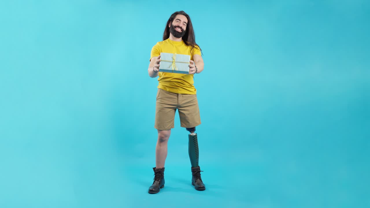 Happy man with a prosthetic leg presenting a gift