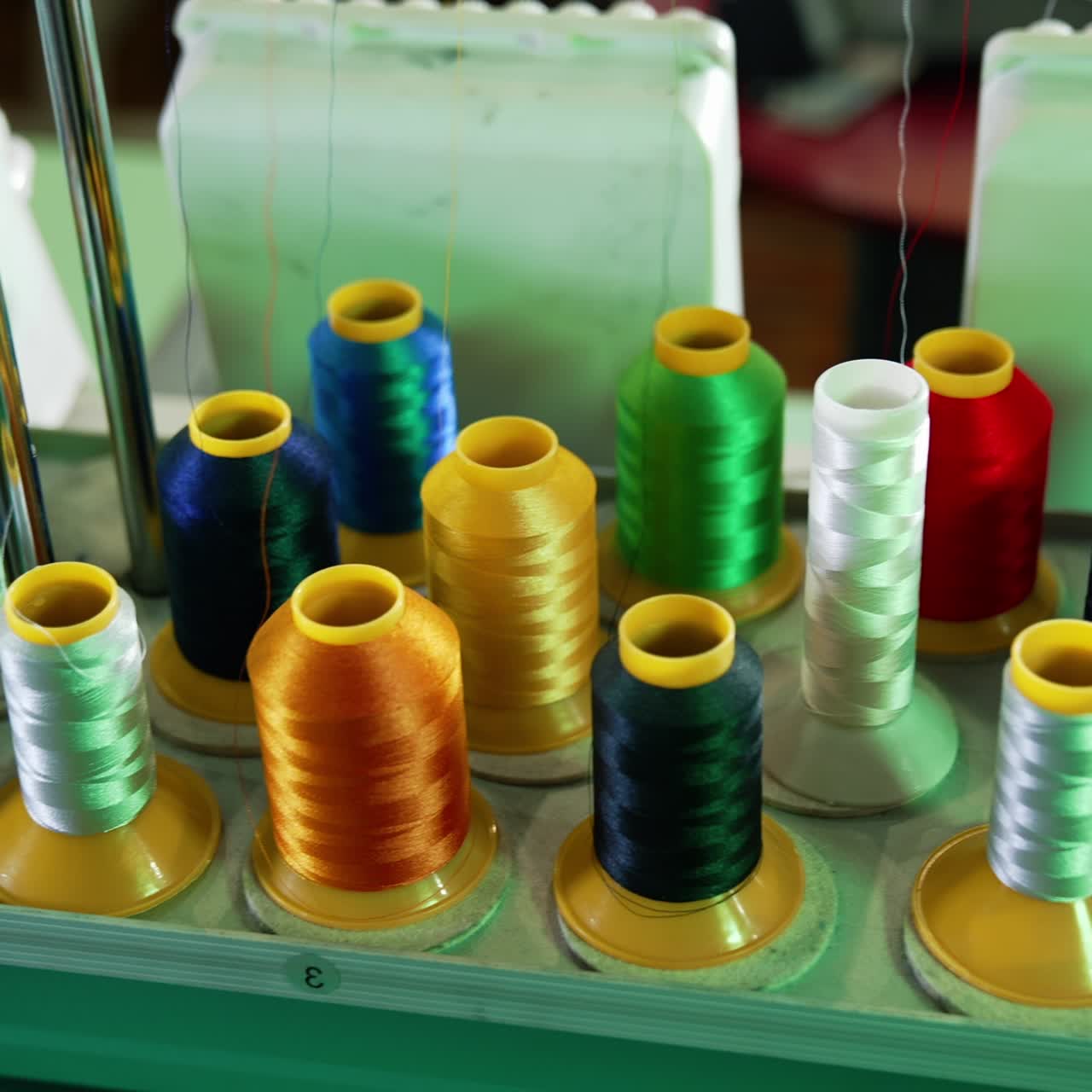 Collection of colorful spools for a dressmaker. Sewing tools for handicraft job. Spools of thread of different colors for tailor