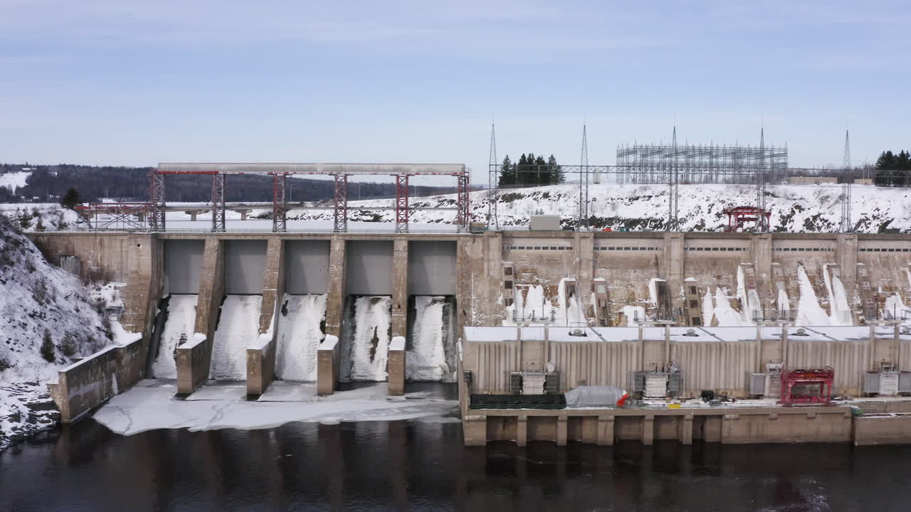 AERIAL: Moving Right Showing Mactaquac Dam On Sunny Winter Day