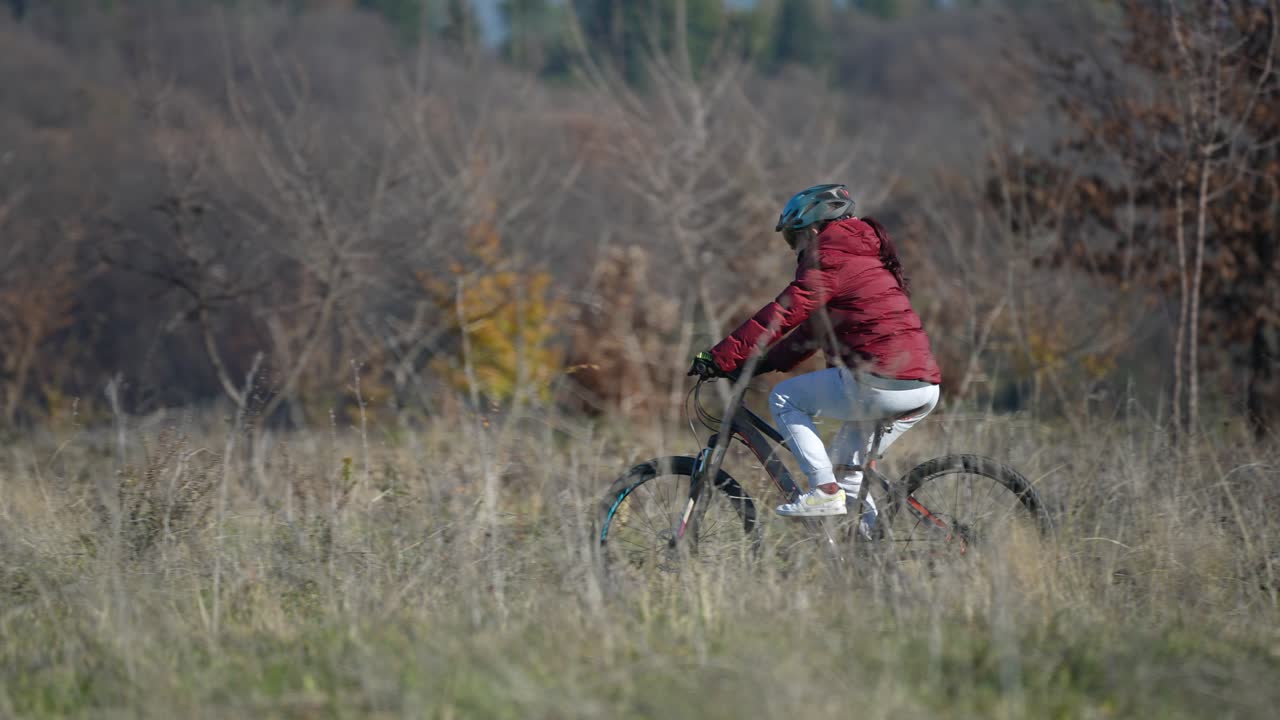 Young Woman Riding Bike in Nature, Clean Air Freedom by Lake, Helmet and Glasses Scenic Journey