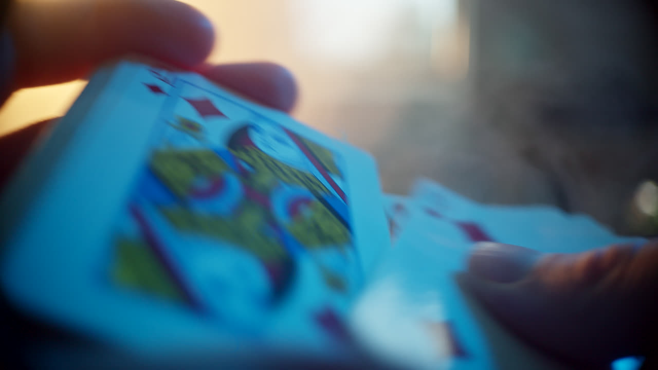 Close-up of hands holding a deck of playing cards