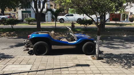 Tilting-view,-blue-dune-buggy-parked-on-street-in-Manzanillo,-Colima,-Mexico