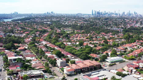 Disparo-Aéreo-De-Un-Dron-Sobrevolando-Haberfield-Con-El-Horizonte-De-La-Ciudad-A-Lo-Lejos-En-Sydney,-Australia