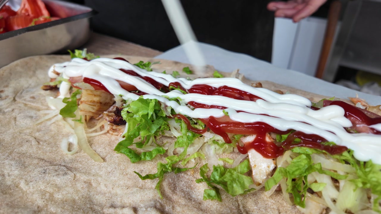 Adding Ketchup and Mayonnaise to a Fresh Kebab Wrap