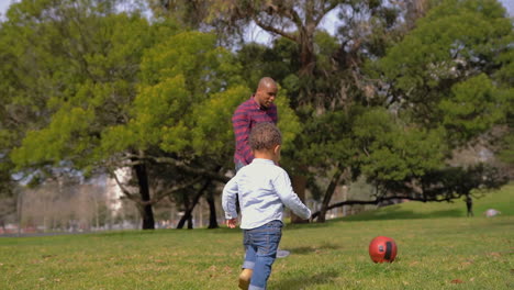 Boy-clapping-hands,-imitating-father,-playing-football-together