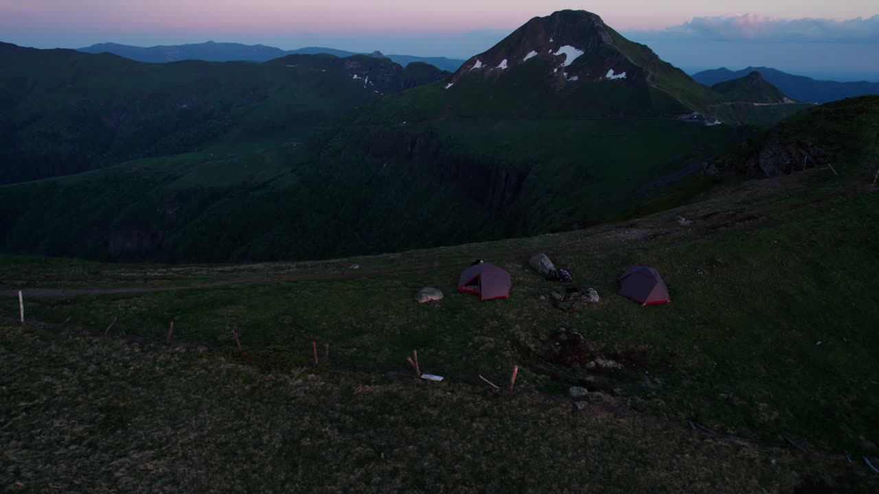 aerial shot around campsite on the ridge of the PUy de la Tourte with the Puy Mary Volcano in the background, Cantal departement, Auvergne Rhone Alpes region, France