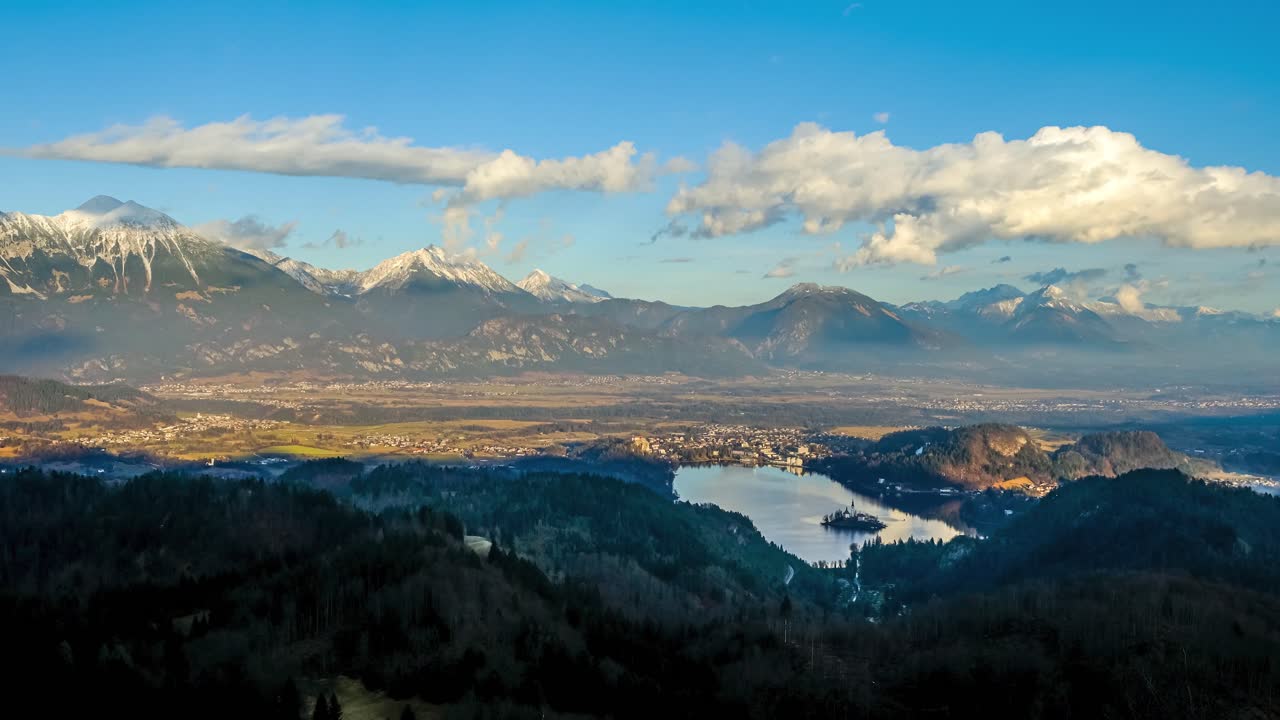 Panoramic Sunset looking over Lake Bled in the winter time. Karavanke Alps in the background with clouds building up over the Alps.