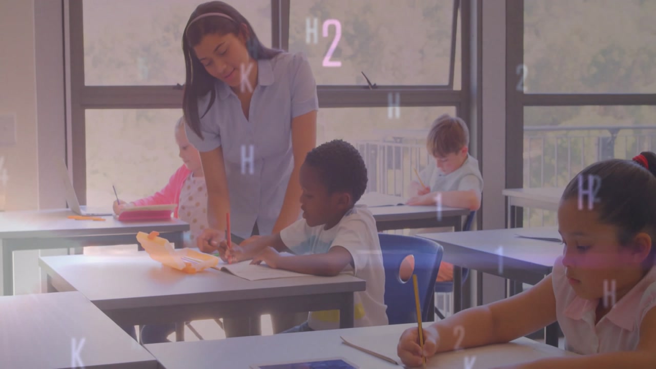 Teacher entering classroom and guiding student writing by pointing worksheet while others writing