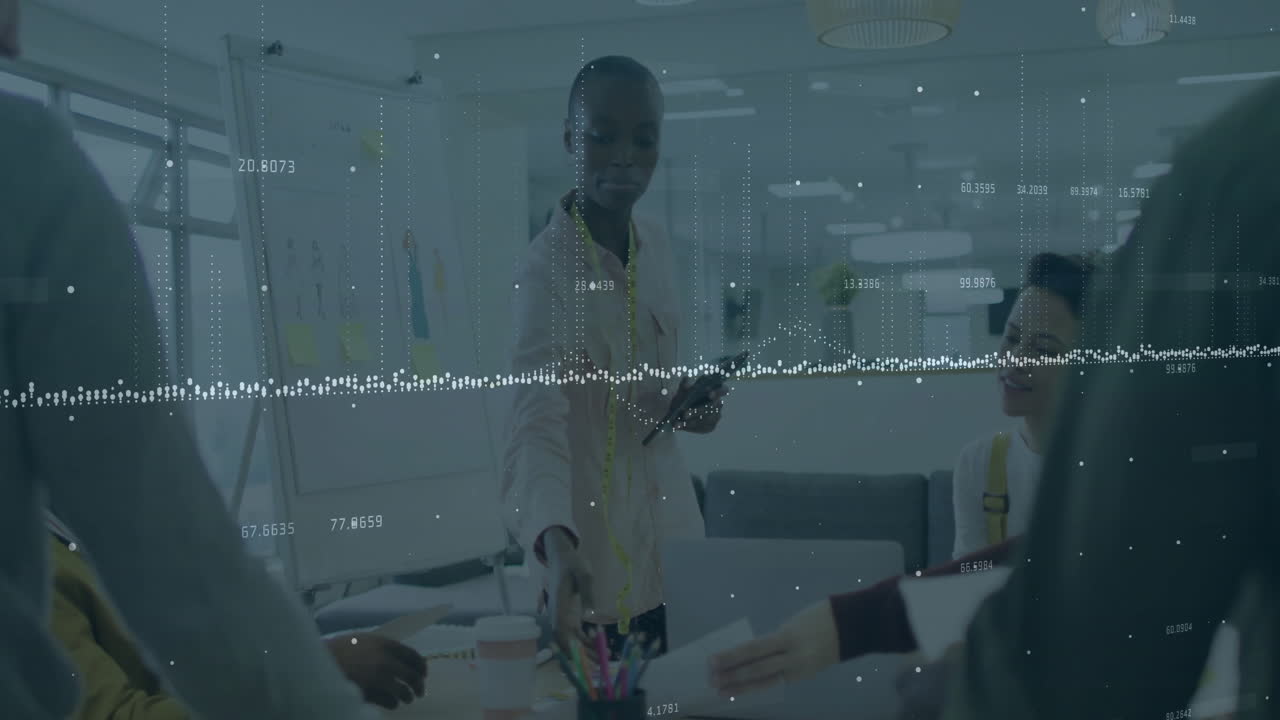 Animation of financial data processing over diverse colleagues having meeting in office